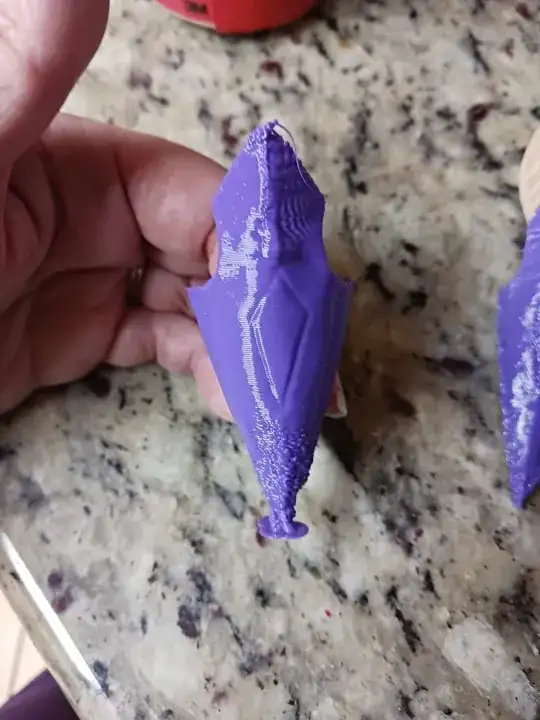 Photo of one of the printed models with poorly extruded bottom and top Photo of one of the printed models with poorly extruded bottom and top