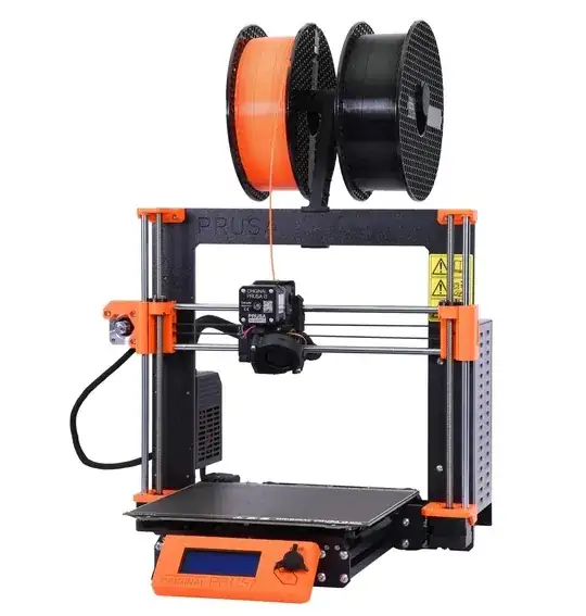 Prusa i3 MK3 printer with a spool of filament above it, the filament fed directly into the top of the X carriage