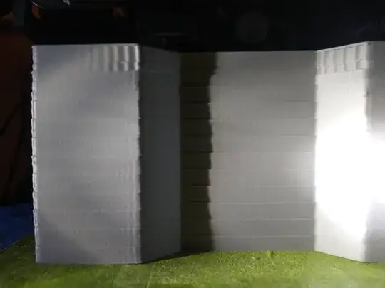 3D print of a Z-direction-extruded rectangle with a trapezoidal segment subtracted from the middle of the long side