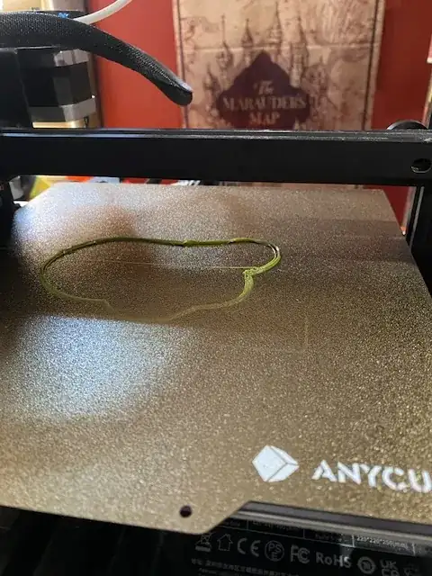 Photo of the first few layers of a printed model but front edge is very thin on the build plate