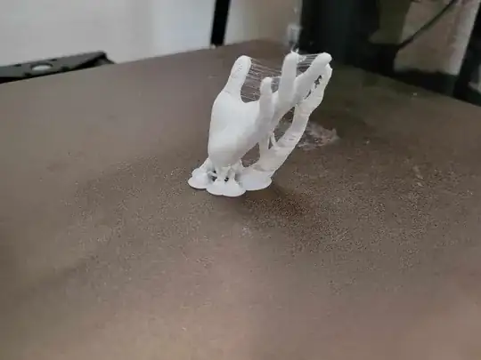 Photo of a 3D printed model of a hand with stringing between the fingers and gaps on the fingers